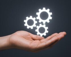 hand-presenting-glowing-gears-concept-for-innovation-technology-solutions-and-engineering-on-dark-background-photo